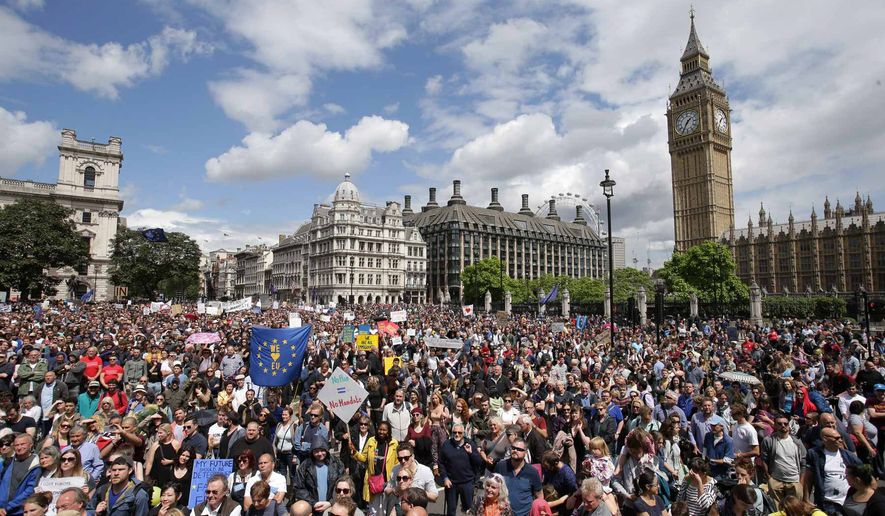 "Remain" supporters demonstrate in Parliament Square, London, to show their support for the European Union in the wake of the referendum decision for Britain to leave the EU, known as "Brexit", Saturday July 2, 2016. Demonstrators wearing EU flags as capes and with homemade banners saying "Bremain" and "We Love EU" gathered on the streets for the March for Europe rally. At rear right is the Elizabeth Tower containing Big Ben. Associated Press photo