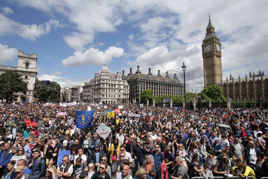 "Remain" supporters demonstrate in Parliament Square, London, to show their support for the European Union in the wake of the referendum decision for Britain to leave the EU, known as "Brexit", Saturday July 2, 2016. Demonstrators wearing EU flags as capes and with homemade banners saying "Bremain" and "We Love EU" gathered on the streets for the March for Europe rally. At rear right is the Elizabeth Tower containing Big Ben. Associated Press photo