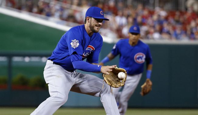 FILE - In this June 13, 2016, file photo, Chicago Cubs third baseman Kris Bryant fields a ball hit by Washington Nationals&#x27; Ryan Zimmerman during a baseball game in Washington. The Cubs became the first team since the 1976 Cincinnati Reds&#x27; Big Red Machine to have five players voted as All-Star Game starters when their entire infield earned the honor Tuesday along with center fielder Dexter Fowler.¶   First baseman Anthony Rizzo, second baseman Ben Zobrist, shortstop Addison Russell and thir baseman Bryant also were elected. The only other team to start four infielders was the 1963 St. Louis Cardinals. (AP Photo/Alex Brandon, File)