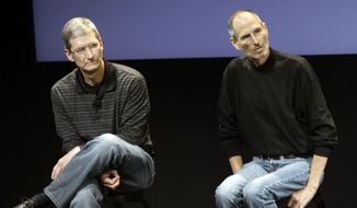This July 16, 2010, file photo shows Apple&#39;s Tim Cook, left, and Steve Jobs, right, during a meeting at Apple in Cupertino, Calif. Apple wants to encourage millions of iPhone owners to register as organ donors through a software update that will add an easy sign-up button to the health information app that comes installed on every smartphone the company makes. (AP Photo/Paul Sakuma, File)
