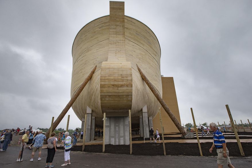 Visitors roam around a replica Noah's Ark as rain clouds pass overhead at the Ark Encounter theme park during a media preview day, Tuesday, July 5, 2016, in Williamstown, Ky. The long-awaited theme park based on the story of a man who got a warning from God about a worldwide flood will debut in central Kentucky this Thursday. The Christian group behind the 510 foot-long wooden ark says it will demonstrate that the stories of the Bible are true. Its construction has rankled opponents who say the attraction will be detrimental to science education. (AP Photo/John Minchillo)