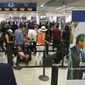 In this Thursday, May 26, 2016, photo, travelers stand in line as they prepare to pass through a Transportation Security Administration checkpoint at Miami International Airport, in Miami. (AP Photo/Alan Diaz) **FILE**
