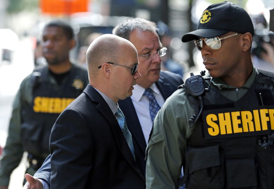 Lt. Brian Rice, second from left, one of the six members of the Baltimore Police Department charged in connection to the death of Freddie Gray, arrives at a courthouse for opening statements in his trial in Baltimore, Thursday, July 7, 2016. (AP Photo/Patrick Semansky)