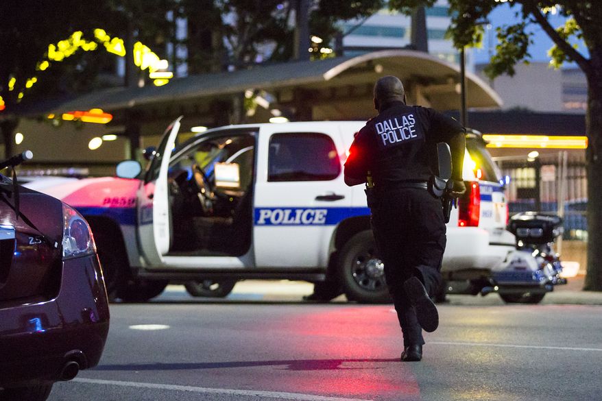 Dallas Police respond after shots were fired at a Black Lives Matter rally in downtown Dallas on Thursday, July 7, 2016. (The Dallas Morning News via Associated Press)