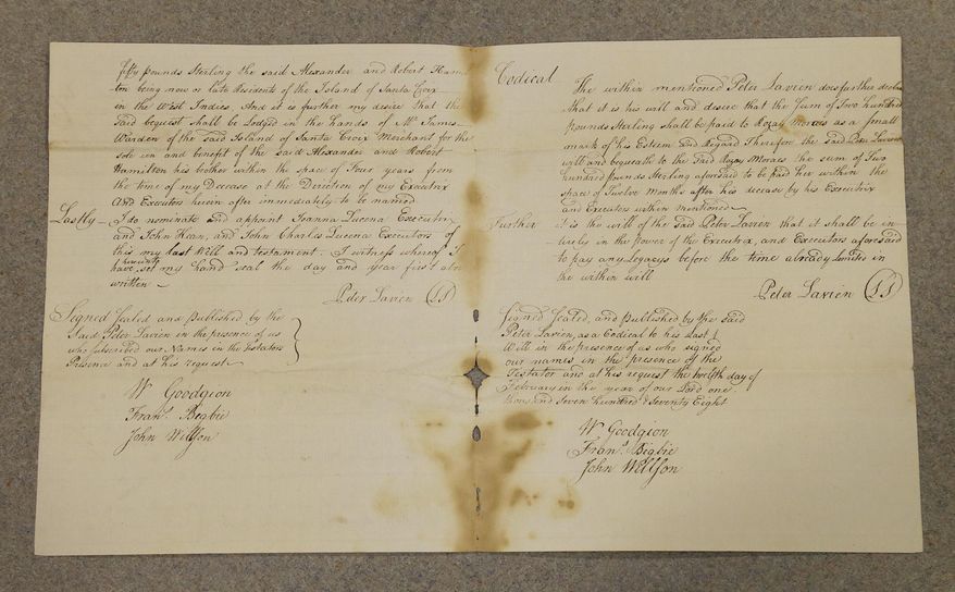 In a photo taken Wednesday, July 6, 2016, a will belonging to Peter Lavien, Alexander Hamilton's half brother, is displayed at the Liberty Hall Museum at Kean University in Union, N.J. Twenty miles from the Broadway theater where fans are spending thousands of dollars to see the smash hit "Hamilton," a group of scholars dedicated to studying the nation's first treasury secretary will gather this week to unveil new artifacts and retrace a piece of history they hope can soften some of Hamilton's rough edges. (AP Photo/Julio Cortez)