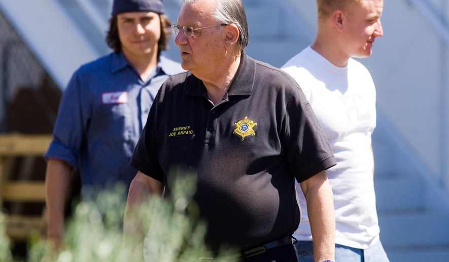 FILE - In this May 6, 2010, file photo, Maricopa County Sheriff Joe Arpaio talks with workers after an immigration raid on a business in Phoenix. Lawyers challenging identity theft laws that were used to charge hundreds of immigrants in Arizona are asking a judge to sanction Arpaio's Office for a sergeant's destruction of notes from his discussions with prosecutors about enforcing the statutes, Thursday, July 7, 2016. (Michael Schennum/The Arizona Republic via AP) MARICOPA COUNTY OUT; MAGS OUT; NO SALES; MANDATORY CREDIT