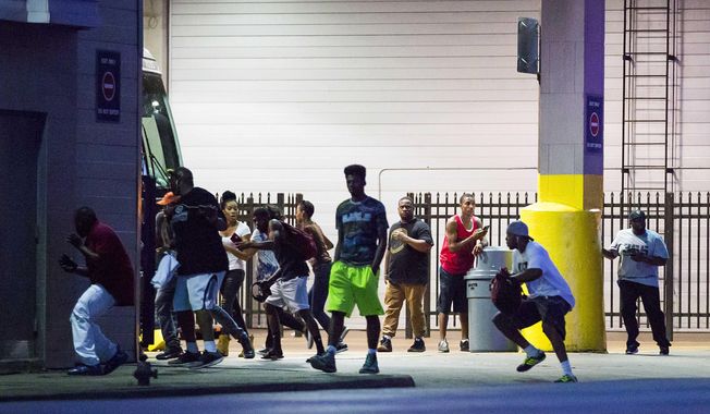 Bystanders run for cover after shots fired at a Black Live Matter rally in downtown Dallas on Thursday, July 7, 2016. Dallas protestors rallied in the aftermath of the killing of Alton Sterling by police officers in Baton Rouge, La. and Philando Castile, who was killed by police less than 48 hours later in Minnesota. (Smiley N. Pool/The Dallas Morning News)