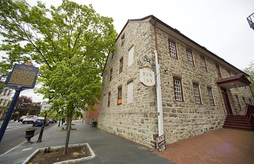 This photo taken May 10, 2016, shows the exterior of The Sun Inn on Main Street in Bethlehem, Pa. The Moravian Sun Inn was an 18th-century inn built by the Moravians to provide accommodations for non-Moravian merchants who had business with the community. Many people prominent during the American Revolution stayed there, including George Washington, Alexander Hamilton, Benjamin Franklin, John Adams, Samuel Adams, John Hancock, and the Marquis de Lafayette. On Sept. 22, 1777, fourteen members of the Continental Congress signed the register and stayed overnight. (Harry Fisher/The Morning Call via AP)