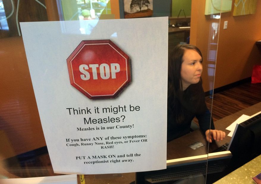 FILE - In this Feb. 7, 2015, file photo, a sign warns of the dangers of measles in the reception area of a pediatrician's office in Scottsdale, Ariz., Saturday, Feb. 7, 2015. Arizona officials are threatening legal action against an immigration detention center south of Phoenix where an outbreak of measles has affected 22 this year, Thursday, July 7, 2016. (AP Photo/Tom Stathis, File)