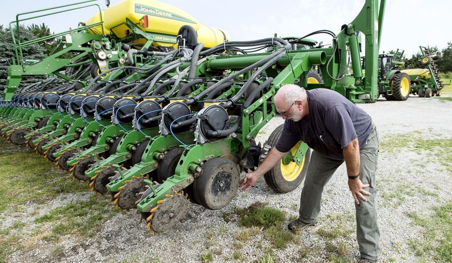 Farmer Mick Minchow takes a look at the fine components of his John Deere planter on Monday, June 20, 2016, at his farm in Waverly, Neb. (Kristin Streff/Lincoln Journal Star via AP)