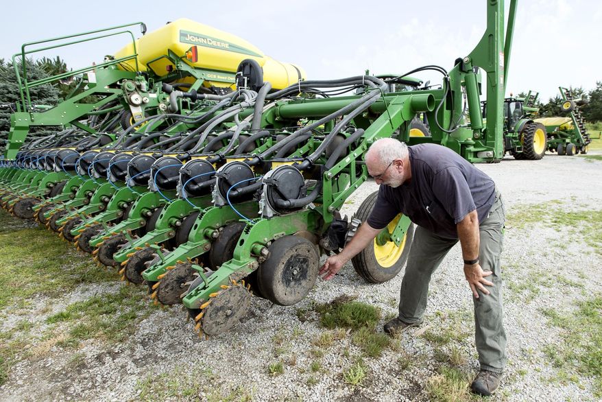Farmer Mick Minchow takes a look at the fine components of his John Deere planter on Monday, June 20, 2016, at his farm in Waverly, Neb. (Kristin Streff/Lincoln Journal Star via AP)