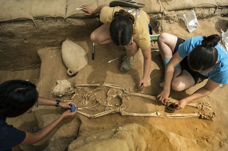 This Tuesday, June 28, 2016 photo shows archeologists excavating an ancient Phillstine cemetery near Ashkelon, Israel. The recent archaeological discovery in Israel may help solve a biblical mystery of where the ancient Philistines came from. A team of archaeologists excavating at the site of the biblical city of Ashkelon have announced it found the first Philistine cemetery ever to be discovered. Now the team is performing DNA, radiocarbon and other tests on bone samples found at the cemetery, dating to the 11th to 8th centuries B.C. (AP Photo/Tsafrir Abayov)