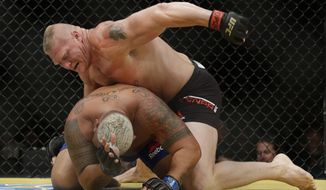 Brock Lesnar, top, fights Mark Hunt during their heavyweight mixed martial arts bout at UFC 200, Saturday, July 9, 2016, in Las Vegas. (AP Photo/John Locher)