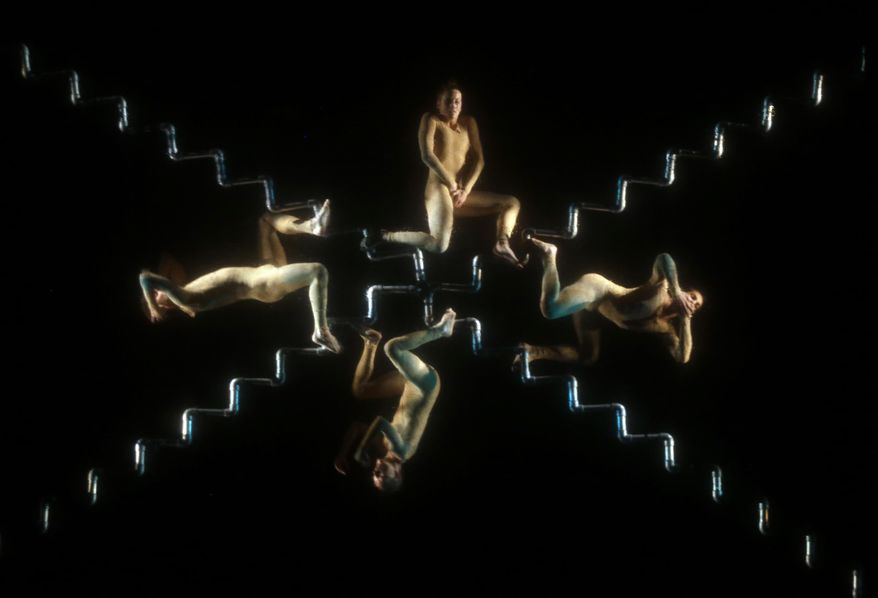 In this Thursday, July 7, 2016 photo, members of the Italian Nogravity Dance Company perform "From hell to paradise, Trips of the soul," at the Julio Mario Santo Domingo Theater in Bogota, Colombia. The dancers are suspended form the air with cables and ropes and perform behind a semi-transparent screen. (AP Photo/Fernando Vergara)