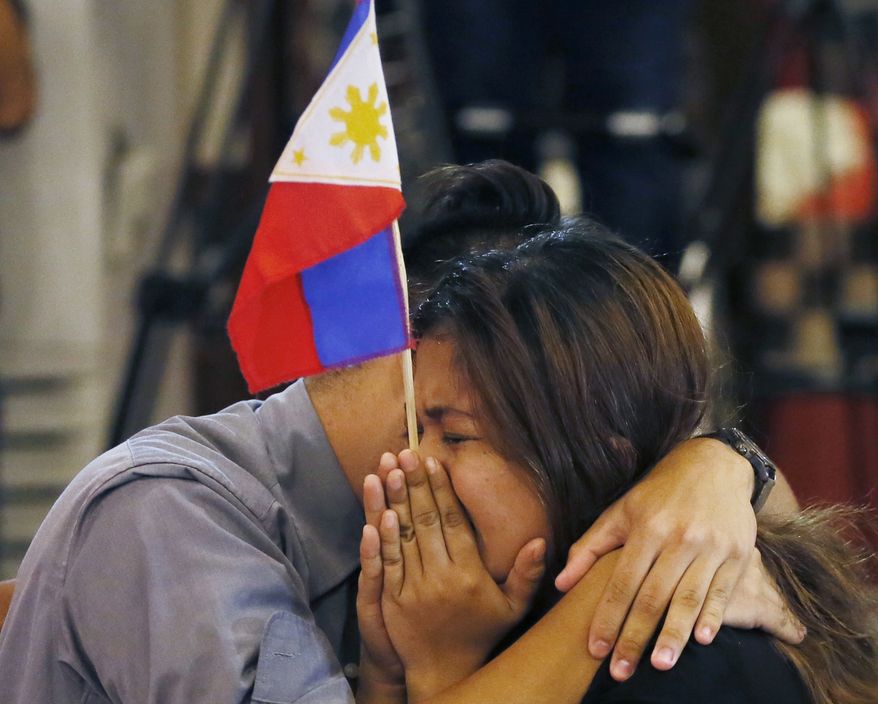 Filipinos were emotional after the Hague-based U.N. international arbitration tribunal ruled Tuesday in favor of the Philippines in its case against China on the dispute in South China Sea. (Associated Press)