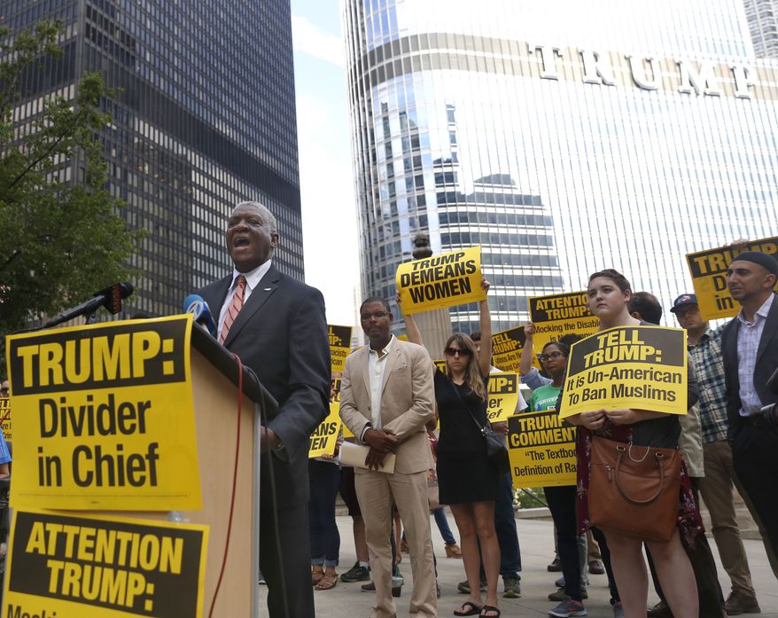 William McNary, left, with Citizen Action Illinois, speaks against Republican presidential candidate Donald Trump, next to the Chicago River across from the Trump International Hotel and Tower in Chicago, Tuesday, July 12, 2016. (AP Photo/Tae-Gyun Kim)