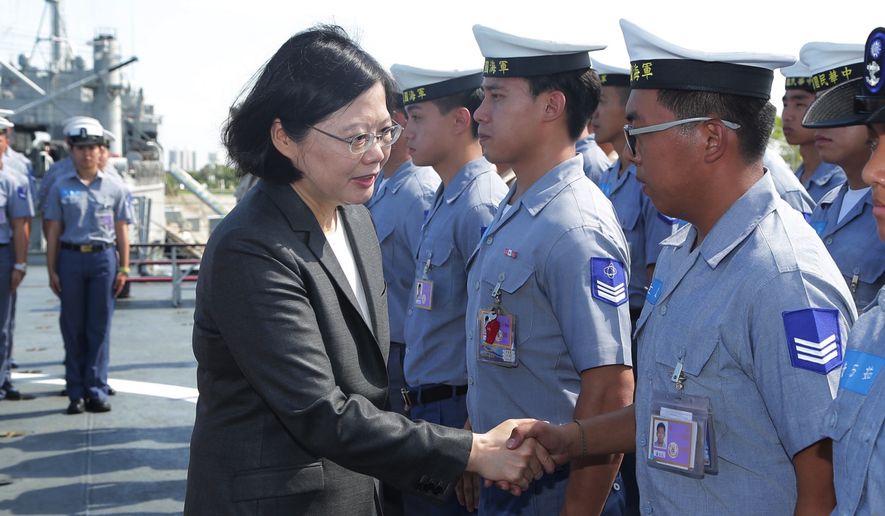 In this image taken and made available by the Taiwan Presidential Office on Wednesday, July 13, 2016, Taiwan&#x27;s President Tsai Ing-wen shakes hands with crew members aboard a Taiwan Navy ship before it sets out to patrol in the South China Sea from the naval base in the southern port city of Khaohsiung, Taiwan. Taiwan&#x27;s Ministry of National Defense said Wednesday it will continue to send planes and ships to the South China Sea to carry out patrol missions and defend Taiwan&#x27;s territory and sovereignty despite the Permanent Court of Arbitration&#x27;s ruling in The Hague, said the Central News Agency.  (Taiwan Presidential Office via AP)