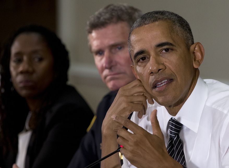 From left: Sherillyn Ifill, president and director-counsel of the NAACP Legal Defense and Educational Fund, and Terry Cunningham, president of the International Association of Chiefs of Police, look to President Barack Obama as he speaks to media at the bottom of a meeting at the Eisenhower Executive Office Building on the White House complex in Washington on July 13, 2016, about community policing and criminal justice with a group made of activists, civil rights, faith, law enforcement and elected leaders. (Associated Press) **FILE**