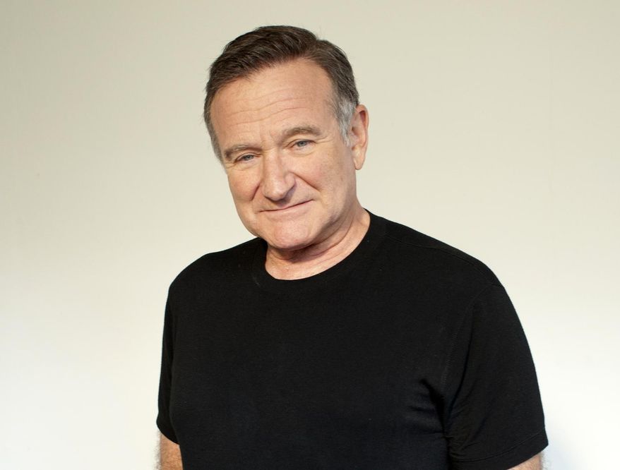 FILE - In this Nov. 5, 2011 file photo, actor Robin Williams poses for a portrait during the "Happy Feet" press junket in Beverly Hills, Calif. Arthur Grace, a photographer and friend of the late Robin Williams, is publishing a book with 190 of his photographs of the late actor-comedian. It will be released next month. (Dan Steinberg/Invision/AP, File)