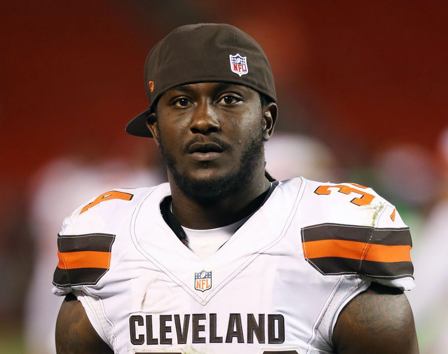 FILE - In this Aug. 13, 2015, file photo, Cleveland Browns running back Isaiah Crowell (34) is shown during an NFL preseason football game against the Washington Redskins in Cleveland. Crowell says he will donate about $35,000 to a fallen officers' fund in Dallas as part of his apology for posting a drawing on Instagram last week showing a police officer getting his throat slashed. In a video posted on Facebook Wednesday, July 13, 2016, Crowell again apologized for the posting and said he would donate his first game check to a fund for the police officers slain and injured during a sniper attack last week. (AP Photo/Ron Schwane, File)