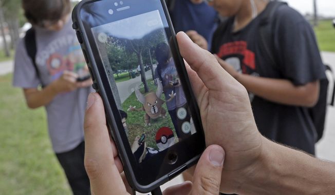 FILE - In this Tuesday, July 12, 2016, file photo, Pinsir, a Pokemon, is found by a group of Pokemon Go players at Bayfront Park in downtown Miami. The &amp;quot;Pokemon Go&amp;quot; craze has sent legions of players hiking around cities and battling with &amp;quot;pocket monsters&amp;quot; on their smartphones. (AP Photo/Alan Diaz, File)