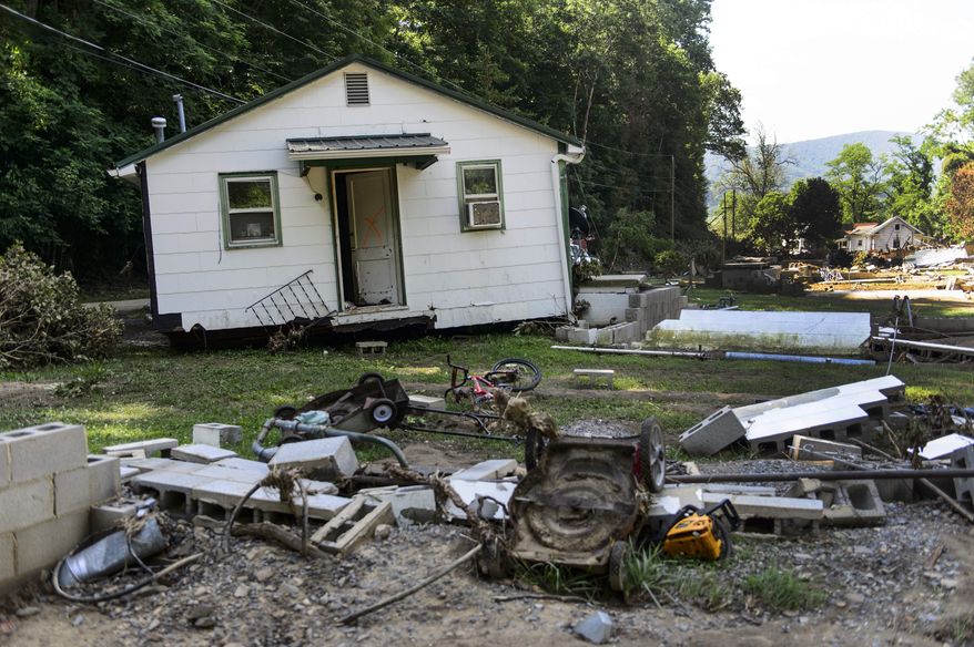 In a Friday, July 1, 2016 photo, the Phillips family home sits several feet away from its broken foundation at the end of Mill Hill Drive in White Sulphur Springs, WV. The family is still searching for 14-year-old Mykala Phillips. Mykala went missing as she was trying to escape from the house with family members during the flood on June 23. Phillips is the only person still unaccounted for from the floods that killed 22 others in West Virginia. (Sam Owens/Charleston Gazette-Mail via AP)