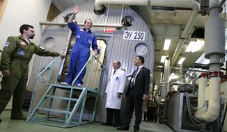 This Nov. 4, 2011, photo released by Moscow&#39;s Institute for Medical and Biological Problems Russia, shows researcher Sukhrob Kamolov leaving a set of windowless modules after a grueling 520-day simulation of a flight to Mars. (Associated Press/IMBP, Oleg Voloshin) **FILE**