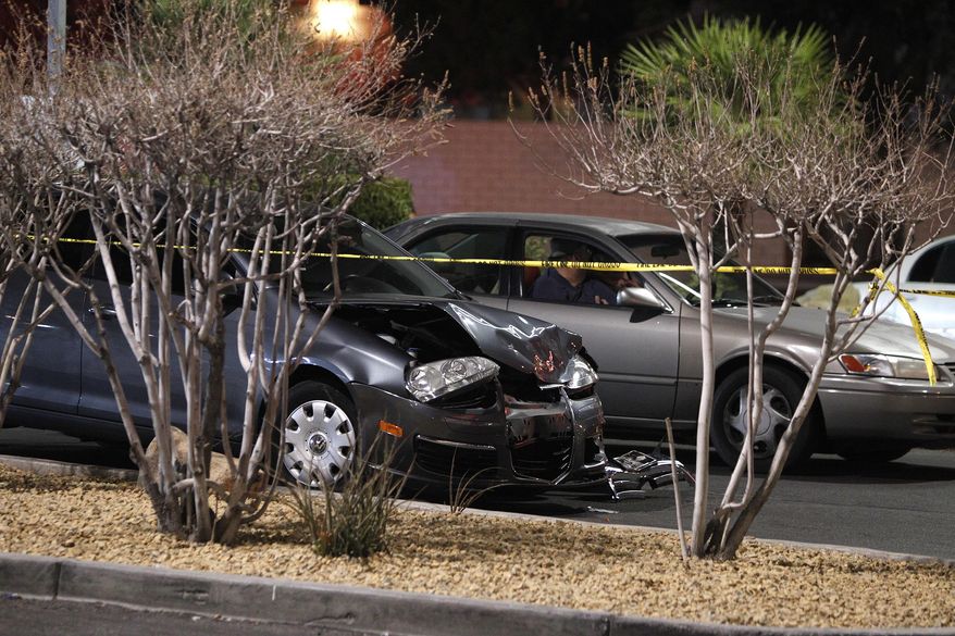 In this Jan. 21, 2014, file photo, a damaged car is seen at the scene of a fatal road rage incident near the corner of Tropicana Avenue and Rainbow Boulevard in Las Vegas. Authorities say a man shot a motorist to death in a vehicle with two children in the backseat in an apparent road-rage confrontation during rush-hour several miles west of the Las Vegas Strip. Nearly eight of every 10 U.S. drivers admit expressing anger, aggression or road rage at least once in the previous year, according to a new survey released Thursday, July 13, 2016, by the AAA Foundation for Traffic Safety. (John Locher/Las Vegas Review-Journal via AP, File)