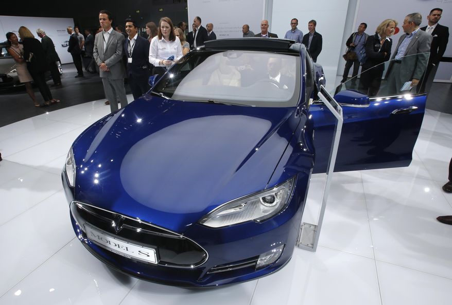 FILE - In this Sept. 15, 2015, file photo, a Tesla Model S is on display on the first press day of the Frankfurt Auto Show IAA in Frankfurt, Germany. Consumer Reports magazine is calling on electric car maker Tesla Motors to change the name of its Autopilot semi-autonomous driving system and to disconnect the automatic steering feature after a fatal crash in Florida. The magazine says in a statement that calling the system Autopilot promotes a dangerous assumption that Teslas can drive themselves. (AP Photo/Michael Probst, File)