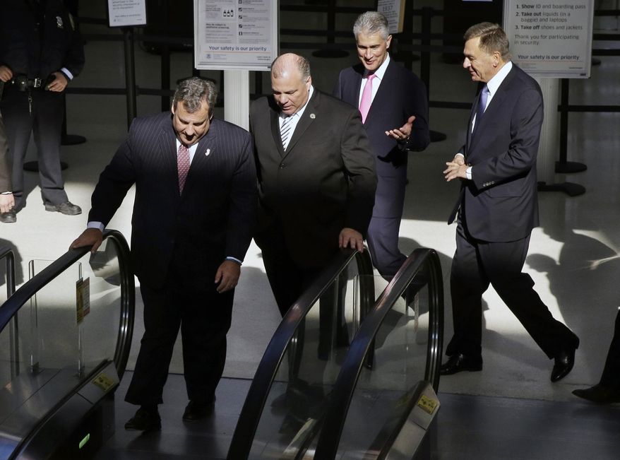 FILE - In this Thursday, Nov. 14, 2013 file photo, New Jersey Gov. Chris Christie, left, New Jersey Senate President Steve Sweeney, second left, United Airlines CEO Jeff Smisek, third left, and New York/New Jersey Port Authority Chairman David Samson, fourth left, walk together at Newark Liberty International Airport, in Newark, N.J. David Samson, the former chairman of the agency that controls New York City-area bridges, tunnels and airports arrived at a New Jersey courthouse Thursday, July 14, 2016, ahead of a planned court appearance and a news conference by federal investigators. The U.S. attorney's office in New Jersey has been investigating whether Samson, a political mentor to Republican Gov. Chris Christie, wrongfully used his Port Authority of New York and New Jersey post to get United Airlines to provide direct air service to South Carolina in 2014 to make it easier to get to his vacation home. (AP Photo/Mel Evans,file)