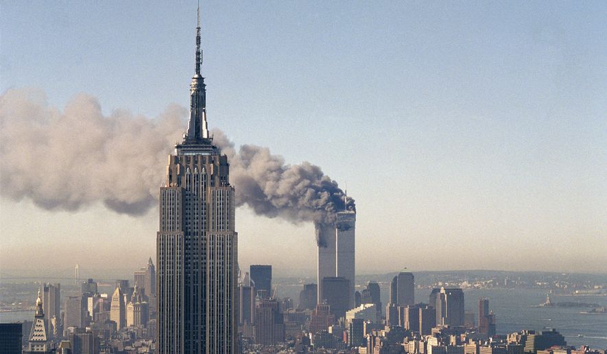 FILE - In this Sept. 11, 2001 file photo the twin towers of the World Trade Center burn behind the Empire State Building in New York after terrorists crashed two planes into the towers causing both to collapse. The government is preparing to release a once-classified chapter of a congressional report about the attacks of Sept. 11, that questions whether Saudi nationals who helped the hijackers with things like finding apartments and opening bank accounts knew what they were planning. House Minority Leader Nancy Pelosi said Friday July 15, 2016, that the release of the 28-page chapter is &quot;imminent.” (AP Photo/Marty Lederhandler)