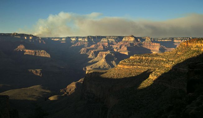 A wildfire burns on the north rim of the Grand Canyon as seen from the Bright Angel Trail below the south rim of the canyon in Grand Canyon National Park in Arizona, Thursday, July 14, 2016. (David Wallace/The Arizona Republic via AP)
