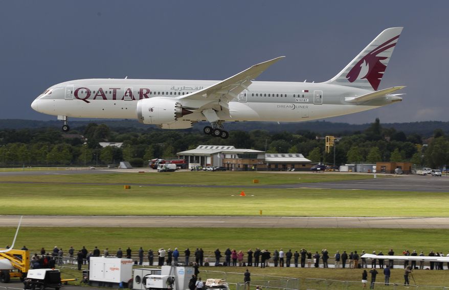 FILE- in this file photo dated Wednesday, July 11, 2012, onlookers watch as a Qatar Airways Boeing 787 Dreamliner lands during an aerial display at the Farnborough International Airshow, in Farnborough, England. The state-owned Commercial Aircraft Corp. of China, known as Comac, announced plans this week at Farnborough airshow 2016, for a wide-body aircraft to be built with state-owned Russian maker United Aircraft Corporation, striking at the heart of the market leaders Airbus and Boeing. (AP Photo/Lefteris Pitarakis, FILE)