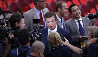 Trump Campaign Chairman Paul Manafort is surrounded by reporters on the floor of the Republican National Convention in Cleveland, Sunday, July 17, 2016. Donald Trump&#39;s presidential campaign has hired new staffers to manage the efforts of newly named vice presidential candidate Gov. Mike Pence of Indiana. (AP Photo/J. Scott Applewhite)
