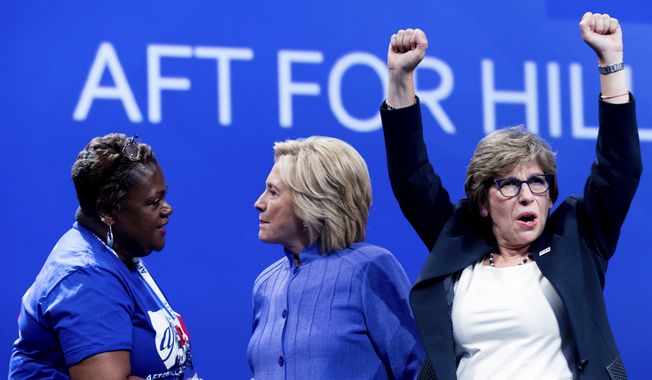 Democratic presidential candidate Hillary Clinton, center, greets a supporter on stage with AFT President Randi Weingarten, right, after speaking at the American Federation of Teachers convention at the Minneapolis Convention Center in Minneapolis, Monday, July 18, 2016. (AP Photo/Andrew Harnik)