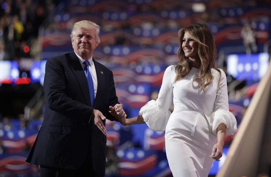 Republican presidential candidate Donald Trump walks off the stage with his wife Melania during the Republican National Convention, Monday, July 18, 2016, in Cleveland. (AP Photo/John Locher)  ** FILE **
