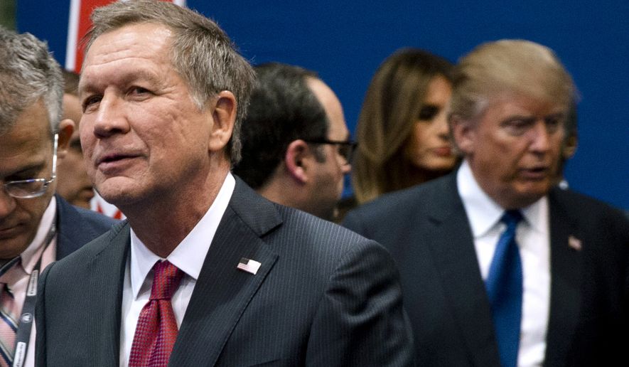 FILE - In this Feb. 6, 2016, file photo, Ohio Gov. John Kasich, left, and Donald Trump, right, speak to reporters after a Republican presidential primary debate hosted by ABC News at Saint Anselm College in Manchester, N.H.   Donald Trump’s top campaign adviser accused Ohio Gov. John Kasich of “embarrassing” his home state by avoiding the Republican convention, opening the gathering with a stark display of party disunity.  (AP Photo/Matt Rourke, File)