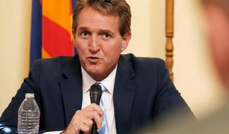 Sen. Jeff Flake, Arizona Republican, who earlier claimed he&#39;d be home mowing his lawn rather than attending his party&#39;s convention in Cleveland, said he watched the first night on television and was dismayed at the attacks on Democrats&#39; presumptive nominee, Hillary Clinton, including calls to jail her. (Associated Press)