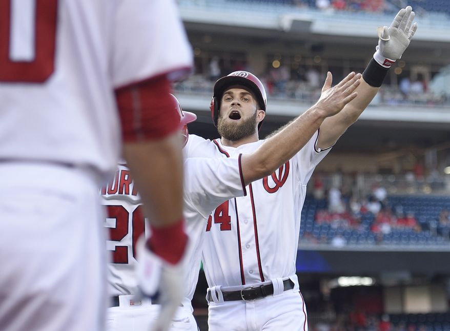 Washington Nationals' Bryce Harper, back, celebrates his two-run home run with Daniel Murphy, center, during the first inning of a baseball game against the Los Angeles Dodgers, Wednesday, July 20, 2016, in Washington. (AP Photo/Nick Wass)