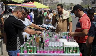 People cool off the summer heat by drinking iced juice in Baghdad, Iraq, Wednesday, July, 20, 2016. Iraqis are enduring the year&#39;s hottest day to date, with temperatures soaring to 51 Celsius degrees (123.8 Fahrenheit) in Baghdad and as much as 53 Celsius (127.4 Fahrenheit) in the southern part of the country. (AP Photo/Karim Kadim)