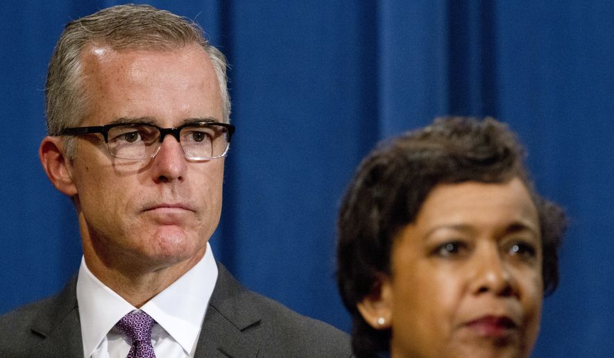 FBI Deputy Director Andrew McCabe, left, and Attorney General Loretta Lynch, listen during a news conference, Wednesday, July 20, 2016, at the Justice Department in Washington, announcing that the U.S. government is seeking the forfeiture of more than $1 billion in assets that federal officials say were misappropriated from a Malaysian sovereign wealth fund. The Justice Department says the funds that were laundered into the U.S. were used for various assets, including real estate and hotel properties, a jet aircraft, fancy artwork and the production of the Oscar-nominated movie, The Wolf of Wall Street. (AP Photo/Jacquelyn Martin) **FILE**