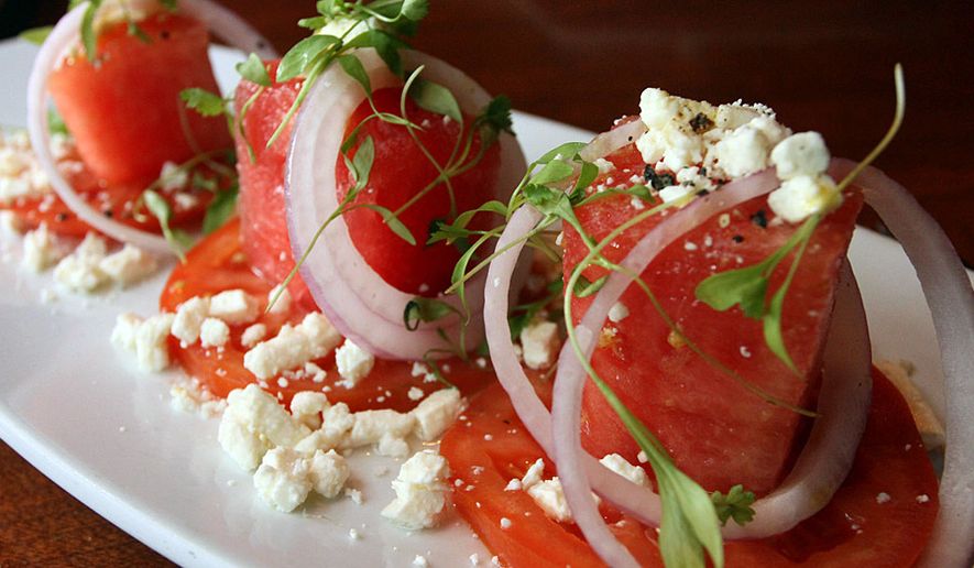 Watermelon salad with summer tomato, feta, red onion and chervil from the Seasons 52 restaurant. (Photograph by Jacquie Kubin / Special to The Washington Times)