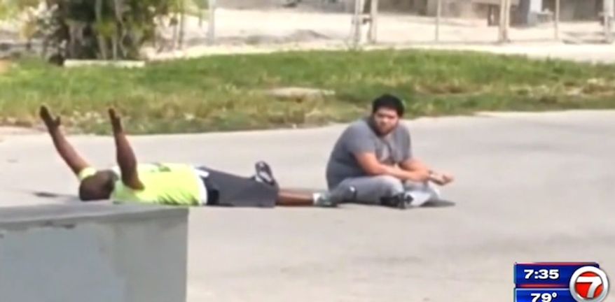 Video shows Charles Kinsey, 47, telling police with his hands in the air that he does not have a weapon and that he is a caretaker for an autistic man. Mr. Kinsey was shot in the leg moments later. (WSVN-7 Miami screenshot)