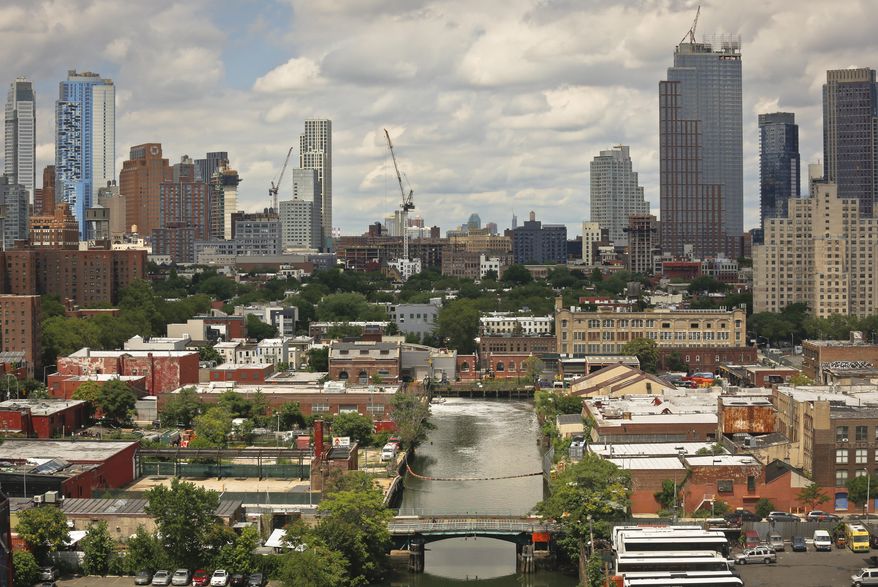 This Tuesday, July 5, 2016 photo shows a view of Brooklyn's Gowanus Canal from the rooftop of 363 Bond Street apartments, a new development from Lightstone, in New York. The canal is a Superfund site polluted with decades' worth of industrial waste and sewage, but the developer says the pending more than half a billion dollars cleanup of the toxic waterway hasn't deterred tenants from flocking to the building, where the rent for a one-bedroom apartment starts in the low $3,000s. (AP Photo/Bebeto Matthews)