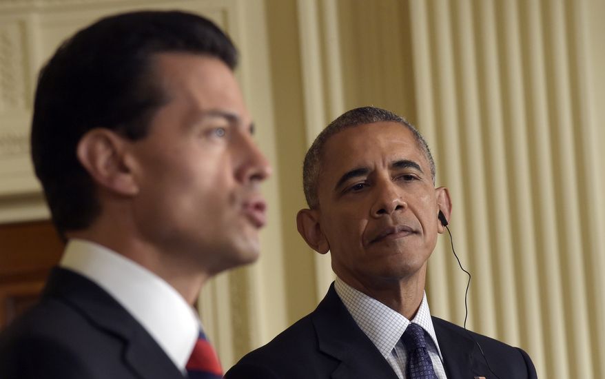 President Barack Obama, right, listens as Mexican President Enrique Pena Nieto, left, speaks during a news conference in the East Room of the White House in Washington, Friday, July 22, 2016. Obama says he has worked to deepen the U.S. relationship with Mexico and that the two countries are not just strategic and economic partners, "we're also neighbors and we're friends." (AP Photo/Susan Walsh)