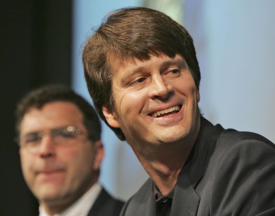 FILE - In this Tuesday, June 26, 2007, file photo, Elliot Schrage, left, Google vice president for global communications & public affairs, listens, as Google Earth & Maps Director John Hanke smiles while listening to remarks from Dr. Jane Goodall during a video teleconference with Goodall from London at Google Earth's offices in New York. Hanke now runs Niantic Labs and is the man behind "Pokemon Go." (AP Photo/Kathy Willens, File)