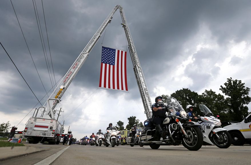 Police motorcycles lead the procession to the cemetery after funeral services for Baton Rouge police officer Matthew Gerald at the Healing Place Church in Baton Rouge, La., Friday, July 22, 2016. Multiple police officers were killed and wounded Sunday morning in a shooting near a gas station in Baton Rouge, less than two weeks after a black man was shot and killed by police here, sparking nightly protests across the city. (AP Photo/Gerald Herbert)