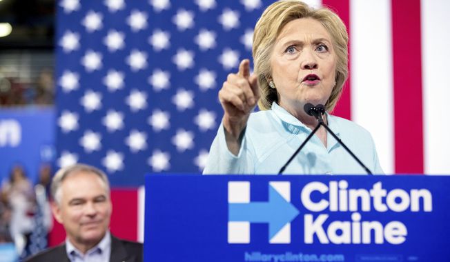 Democratic presidential candidate Hillary Clinton accompanied by Sen. Tim Kaine, D-Va., speaks at a rally at Florida International University Panther Arena in Miami, Saturday, July 23, 2016. Clinton has chosen Kaine to be her running mate. (AP Photo/Andrew Harnik) ** FILE **