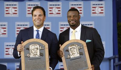 National Baseball Hall of Fame inductees Mike Piazza, left, and Ken Griffey Jr. hold their plaques after an induction ceremony at the Clark Sports Center on Sunday, July 24, 2016, in Cooperstown, N.Y. (AP Photo/Mike Groll)