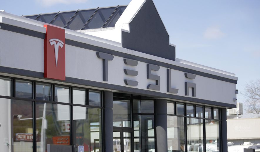 FILE - This April 1, 2015, file photo shows the Tesla Motors new showroom in Salt Lake City. New car dealers in Utah are fighting back against Tesla's Utah Supreme Court push to sell its sleek electronic cars in Utah, arguing that state laws were set up to protect customers and Tesla should have to follow them like everyone else. (AP Photo/Rick Bowmer, File)